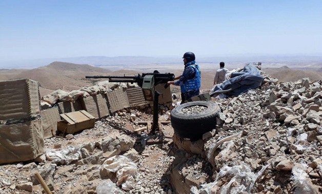 Fighters from the Syrian army units and Hezbollah are seen on the western mountains of Qalamoun, near Damascus - REUTERS