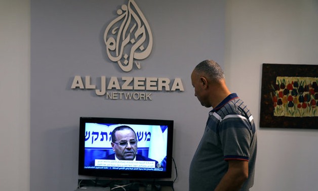 An employee working inside the office of Qatar-based Al-Jazeera network in Jerusalem - REUTERS
