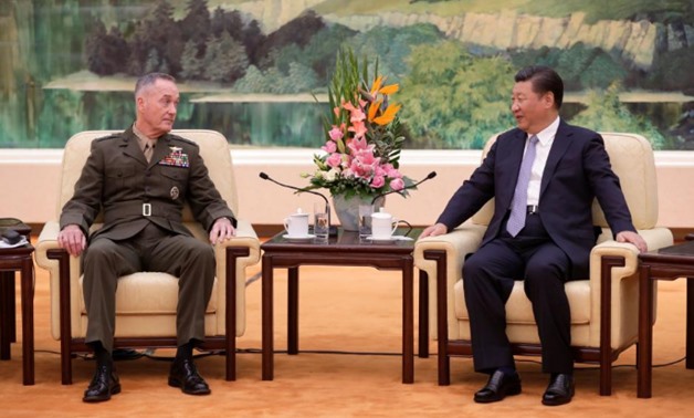 S. Chairman of the Joint Chiefs of Staff Gen. Joseph Dunford chats with President Xi Jinping during a meeting at the Great Hall of the People in Beijing
