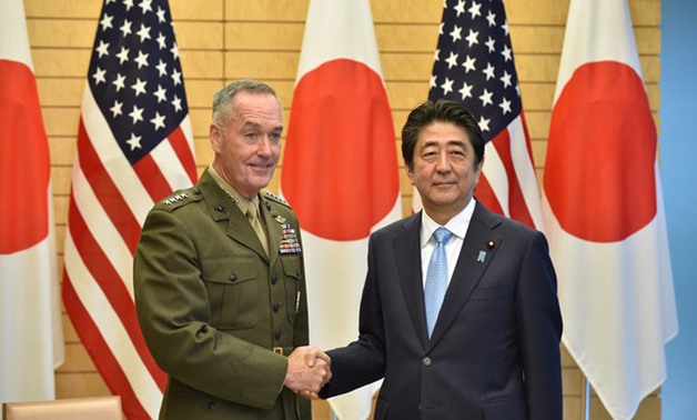 General Joseph Dunford (L), the chairman of the U.S. Joint Chiefs of Staff, shakes hands with Japan's Prime Minister Shinzo Abe at Abe's official residence in Tokyo, Japan August 18, 2017. REUTERS