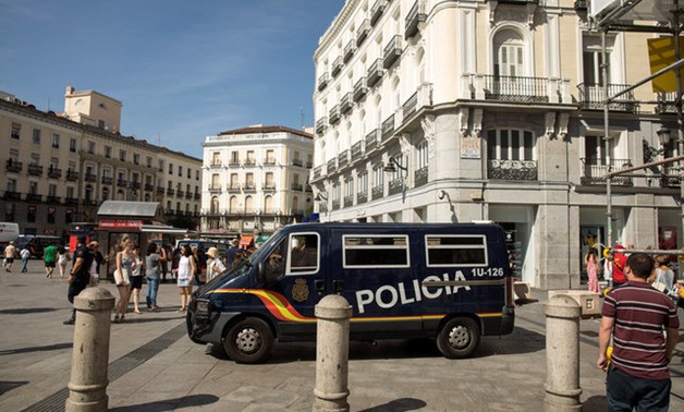 A police van drives by at Madrid's Puerta del Sol square - -REUTERS