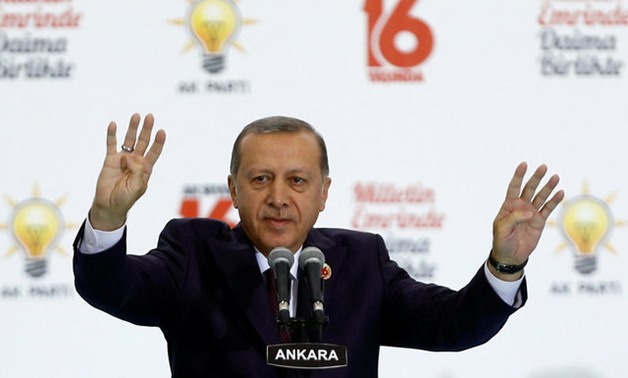 Turkish President Erdogan greets the audience during a ceremony to mark the 16th anniversary of his ruling AK Party's foundation in Ankara - REUTERS