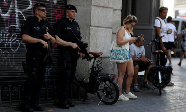 Armed Catalan Mossos d'Esquadra officers stand guard a day after a van crashed into pedestrians at Las Ramblas in Barcelona - REUTERS