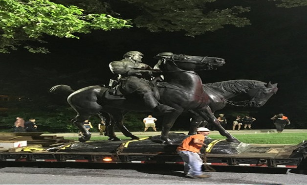 Workers remove the monuments to Confederate generals Robert E. Lee and Thomas "Stonewall" Jackson from Wyman Park in Baltimore - REUTERS
