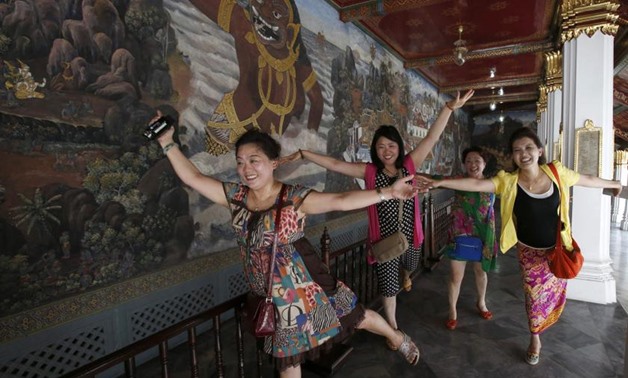 Chinese tourists pose for a picture inside the Grand Palace in Bangkok May 24, 2014. — Reuters 