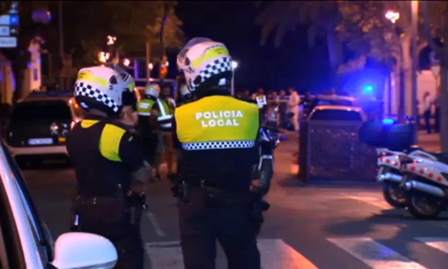 Officers investigate at the scene where police had killed four attackers in Cambrils, south of Barcelona, in this still image taken from Reuters video on August 18, 2017. REUTERS