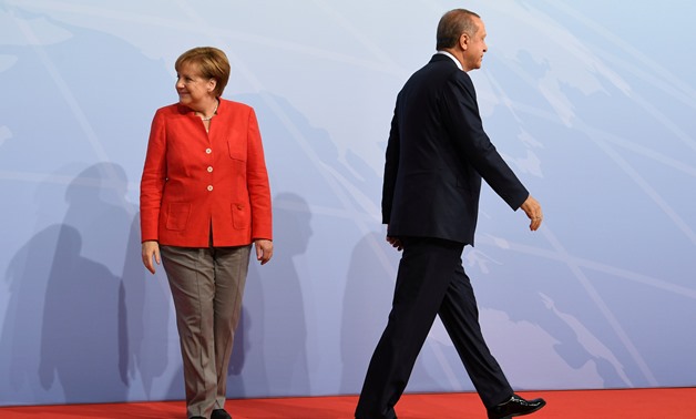 German Chancellor Angela Merkel greets Turkey's President Recep Tayyip Erdogan at the beginning of the G20 summit in Hamburg, Germany, July 7, 2017. REUTERS/Bernd Von Jutrczenka/POOL/File Photo