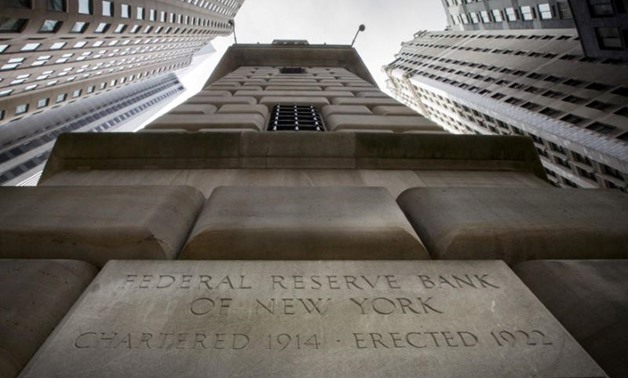 FILE PHOTO: The corner stone of the New York Federal Reserve Bank is seen surrounded by financial institutions in New York City, New York, U.S., March 25, 2015.
Brendan McDermid