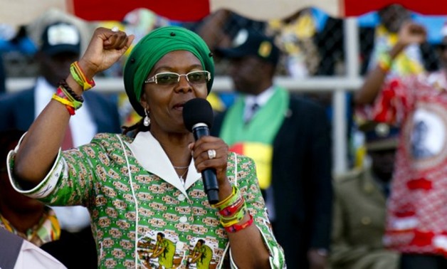 © ALEXANDER JOE / AFP | Zimbabwe's first lady Grace Mugabe raises her fist as she speaks during a rally in Harare on July 28, 2013.