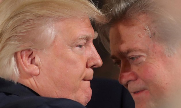 U.S. President Donald Trump talks to chief strategist Steve Bannon during a swearing in ceremony for senior staff at the White House in Washington, U.S. January 22, 2017.