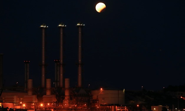 A natural gas-fired power plant recently constructed by Siemens is seen during a partial lunar eclipse of the moon in Delimara, outside the village of Marsaxlokk, Malta, August 7, 2017. Picture taken August 7, 2017. REUTERS/Darrin Zammit Lupi