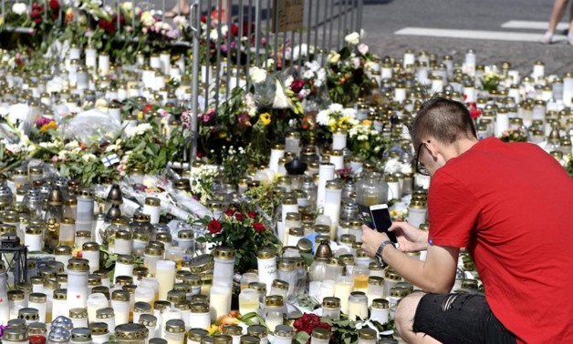 Mourners bring memorial cards, candles and flowers to the Turku Market Square, in Turku, Finland August 20, 2017. Lehtikuva/Vesa Moilanen/via REUTERS