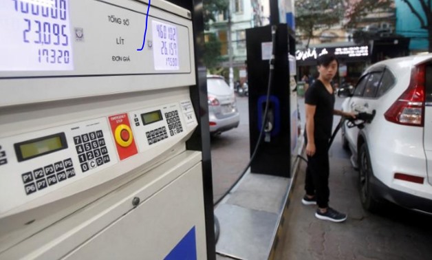 A man pumps petrol for his car at a petrol station in Hanoi, Vietnam December 20, 2016.
Kham/File Photo