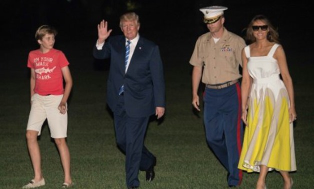 AFP | President Donald Trump, with First Lady Melania Trump and son Barron, returned to the White House on Sunday night after a 17-day "working vacation"