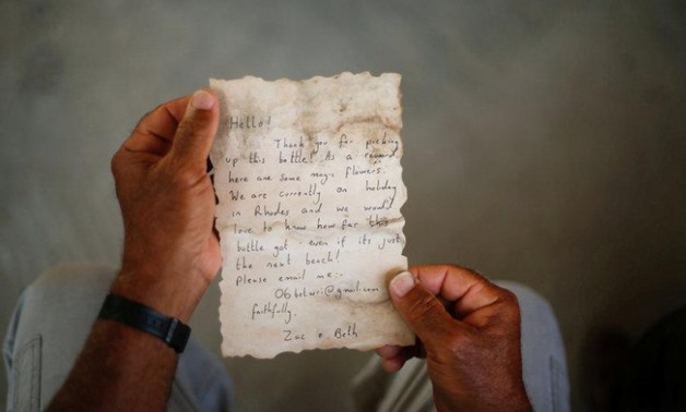 Palestinian fisherman Jihad al-Soltan displays a message that was written by Bethany Wright and her boyfriend Zac Marriner, after he found it in a bottle off a Gaza beach, in Gaza August 21, 2017.
Mohammed Salem