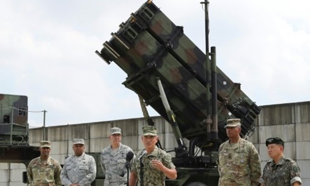 © POOL/AFP | Admiral Harry Harris (3rd R) at a press conference in front of a PAC-3 launch station at Osan Air Base