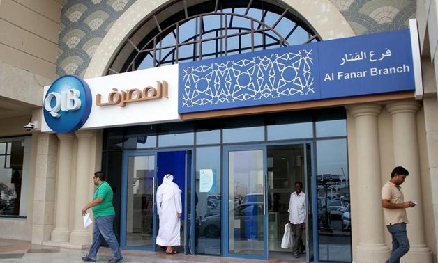  Customers leave one of the branches of Qatar Islamic Bank in Doha April 13, 2016