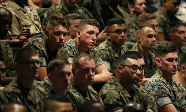 Members of the US military listen to Trump's speech - Reuters