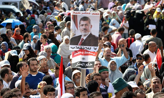 Supporters of Muslim Brotherhood and ousted Egyptian President Mohamed Mursi display a poster of Mursi during a protest in Cairo in 2013. REUTERS/Muhammad Hamed