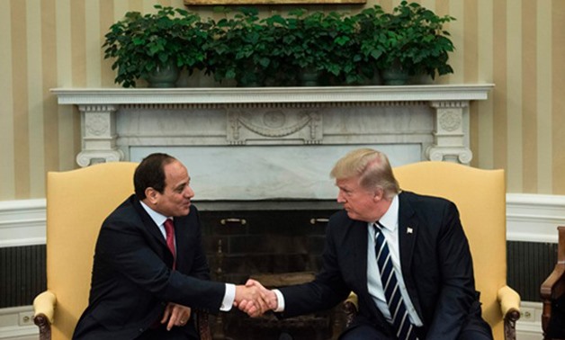 Egypt's President Abdel Fattah al-Sisi and US President Donald Trump shake hands in the Oval Office before a meeting at the White House - AFP/Brendan Smialow
