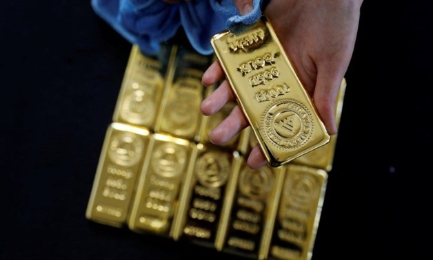 A employee works on 1 kg. gold bars in Ahlatci Metal Refinery in the central
