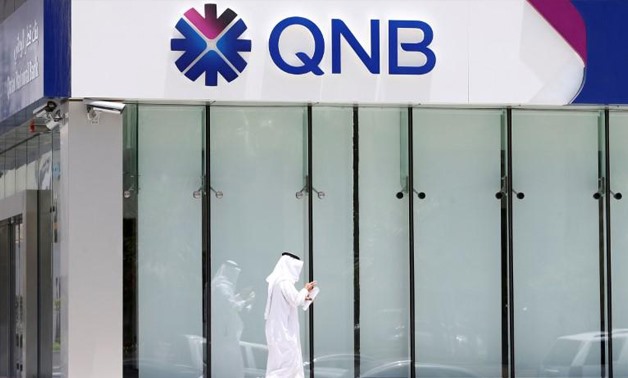 FILE PHOTO: A man walks past a branch of Qatar National Bank (QNB) in Riyadh, Saudi Arabia, June 5, 2017.
Faisal Al Nasser