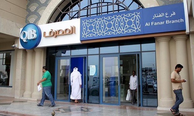 Customers leave one of the branches of Qatar Islamic Bank in Doha April 13, 2016