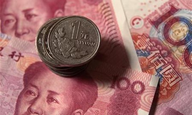 <p>Chinese one yuan coins are placed on 100 yuan banknotes in this illustrative photograph taken in Beijing December 30, 2010.
Petar Kujundzic/Files</p>