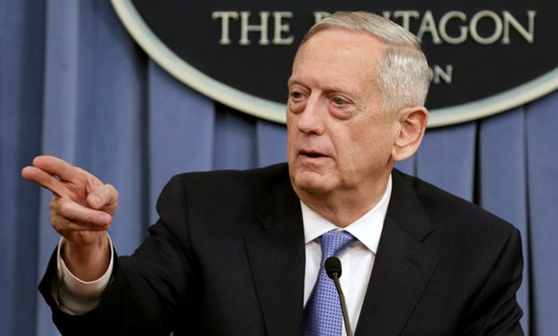 Mattis gestures to the media at the Pentagon in Washington - REUTERS
