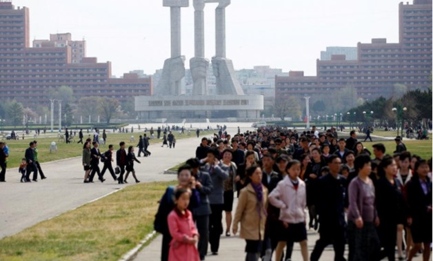 People walk in front of the Monument to the Foundation of the Workers' Party in Pyongyang
