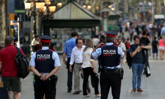 Catalan Mossos d'esquadra officers patrol at Las Ramblas street where a van crashed into pedestrians in Barcelona
