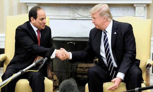 President Abdel Fatah al-Sisi (L) shakes hands with President Donald Trump (R) – Reuters