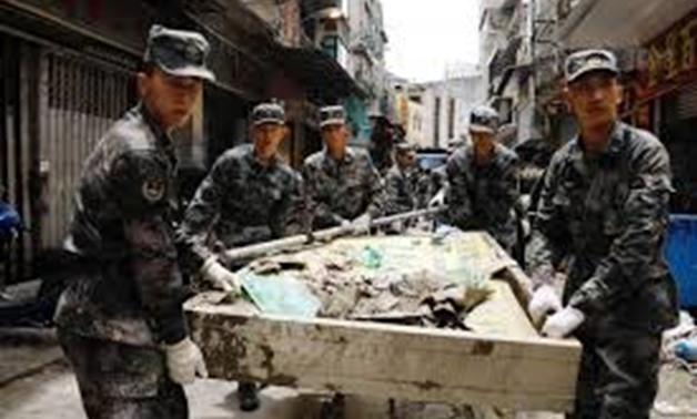 People’s Liberation Army (PLA) soldiers clean debris after Typhoon Hato hits in Macau, China August 25, 2017 - REUTERS
