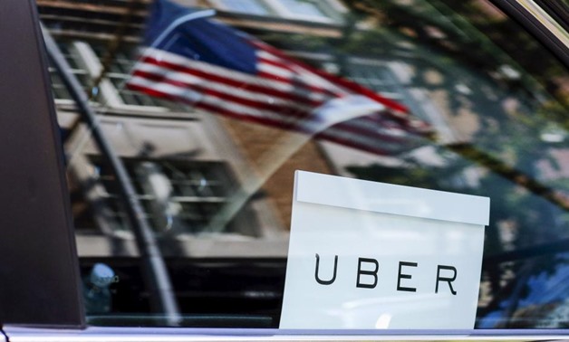 FILE PHOTO - An Uber sign is seen in a car in New York, U.S. June 30, 2015.
Eduardo Munoz/File Photo