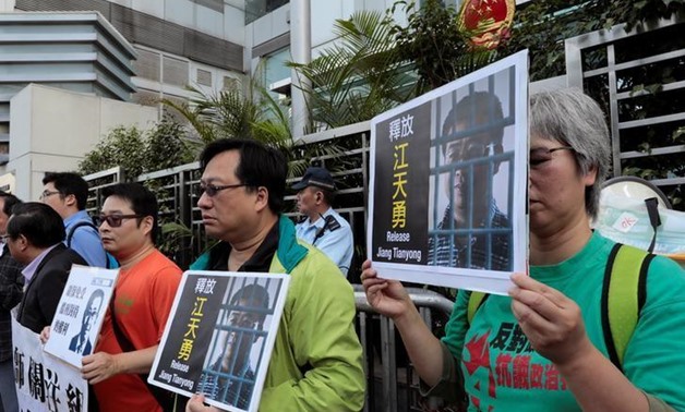 FILE PHOTO: Pro-democracy demonstrators hold up portraits of Chinese disbarred lawyer Jiang Tianyong, demanding his release, during a demonstration outside the Chinese liaison office in Hong Kong, China December 23, 2016.
Tyrone Siu