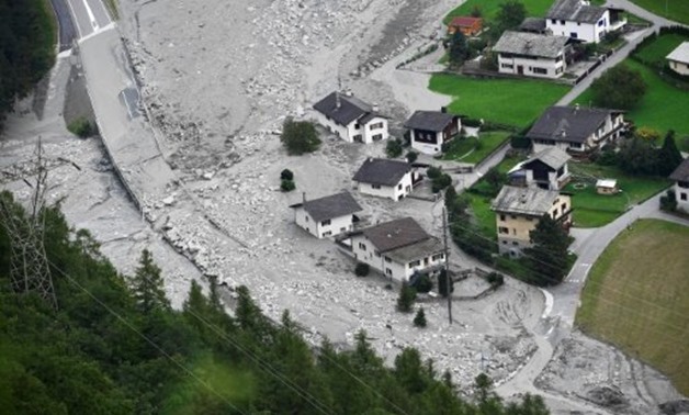 © AFP / by Miguel Medina with Nina Larson in Geneva | Houses covered by stones after a landslide struck during the village of Bondo, Switzerland
