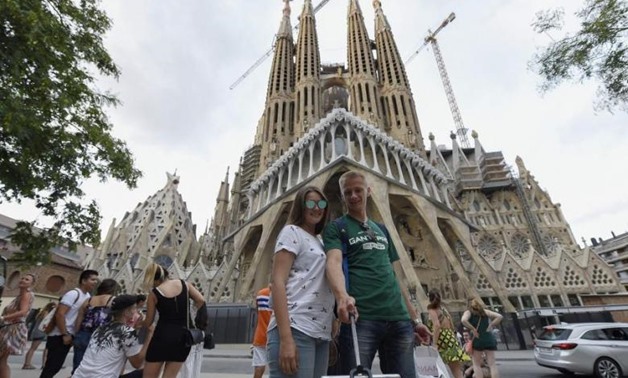 Tourists in front of the Sagrada Familia basilica in Barcelona two days after the attack.