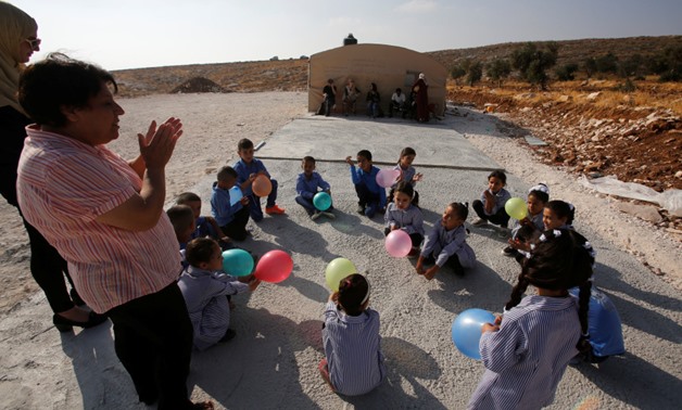 Palestinian schoolchildren play outside a tent where they attend lessons after Israeli troops razed their school building in the West Bank village of Jubbet ad-Dib, near Bethlehem August 24, 2017. REUTERS

