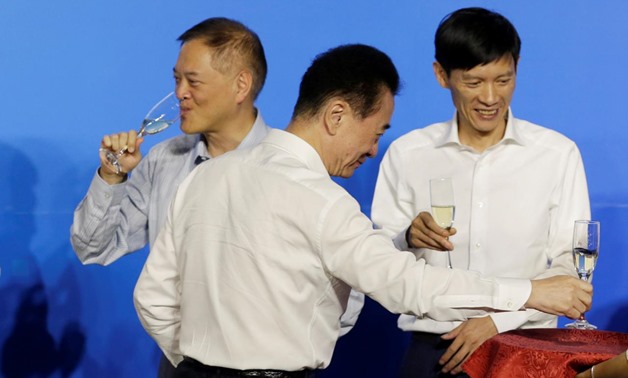 Chairman of Dalian Wanda Group Wang Jianlin (C) and Chairman of R&F Properties Li Silian (C) attend a strategic cooperation signing ceremony in Beijing, China July 19, 2017. Picture taken July 19, 2017.
Jason Lee