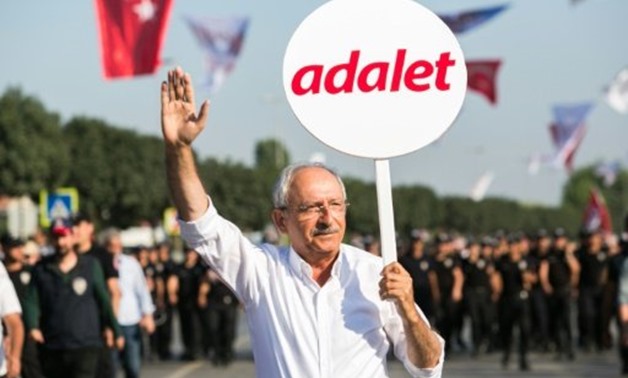 © AFP / by Fulya OZERKAN | Turkey's main opposition Republican People's Party (CHP) leader Kemal Kilicdaroglu, pictured holding a placard that reads "Justice" at the end of a 450 kilometre protest march from Istanbul to Ankara in July