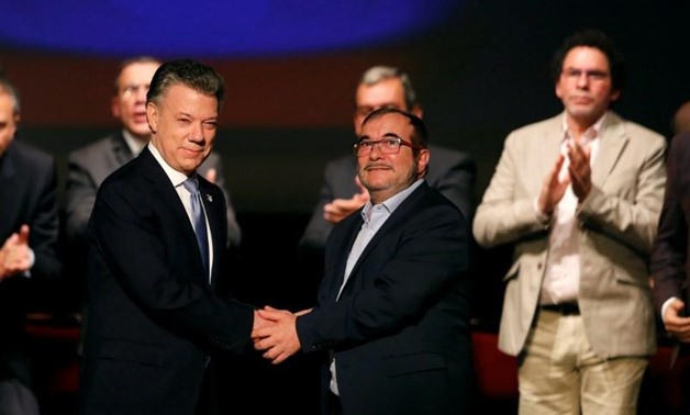 FILE PHOTO: Colombia's President Juan Manuel Santos and Marxist FARC rebel leader Rodrigo Londono, known as Timochenko, shake hands after signing a peace accord in Bogota, Colombia November 24, 2016.
Jaime Saldarriaga