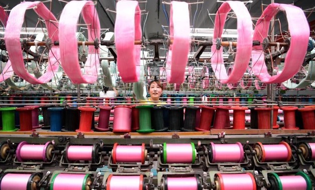 An employee works at a silk factory in Nantong, Jiangsu province, China July 17, 2017.
Stringer