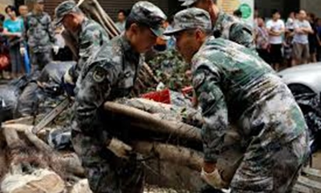 People’s Liberation Army (PLA) soldiers clean branches of an uprooted tree after Typhoon Hato and Tropical storm Pakhar hit Macau, China August 27, 2017.
