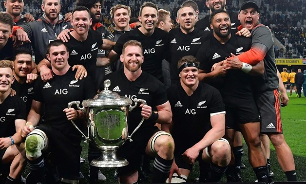 New Zealand captain Kieran Read holds the Bledisloe Cup after defeating Australia in Dunedin-AFP / Marty MELVILLE