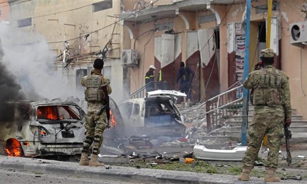 Somali security personnel look towards burning vehicles as they secure an area in Mogadishu on July
- Reuters