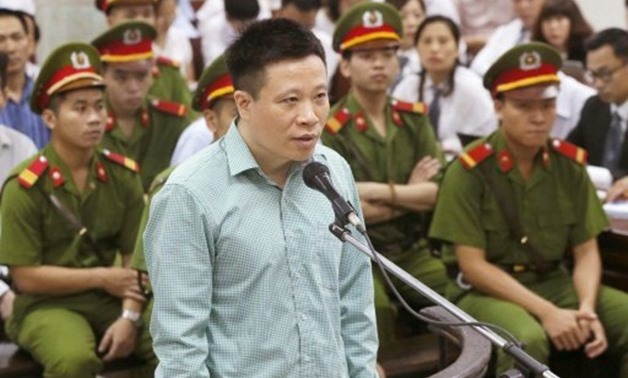 © Vietnam News Agency/AFP | Former Ocean Bank chairman Ha Van Tham stands trial