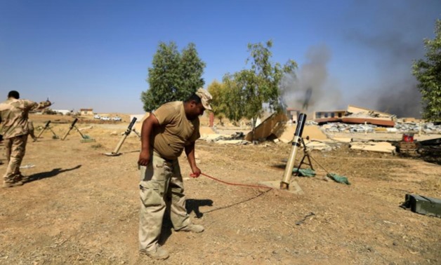 Members of Iraqi Army fire mortar shells during the war between Iraqi army and Shi'ite Popular Mobilization Forces (PMF) against the Islamic State militants in al-Ayadiya, northwest of Tal Afar