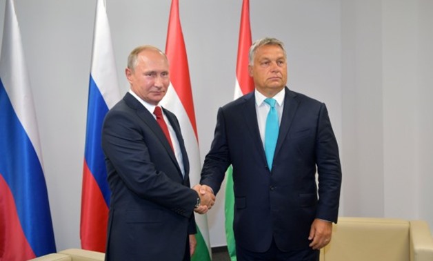 Russian President Vladimir Putin (L) shakes hands with Hungarian Prime Minister Viktor Orban during a meeting in Budapest, Hungary - Reuters