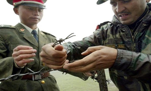  Photo taken in 2006 shows a Chinese soldier (L) and Indian soldier installing a barbed-wire fence at a border crossing in India's northeastern Sikkim state
AFP