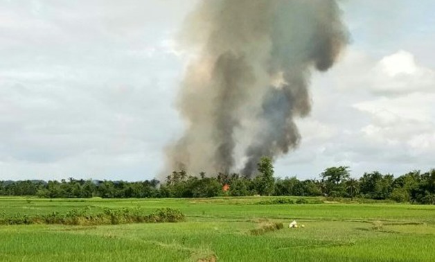 Smoke rises from what is believed to be a burning village near Maungdaw in Myanmar's Rakhine state AFP